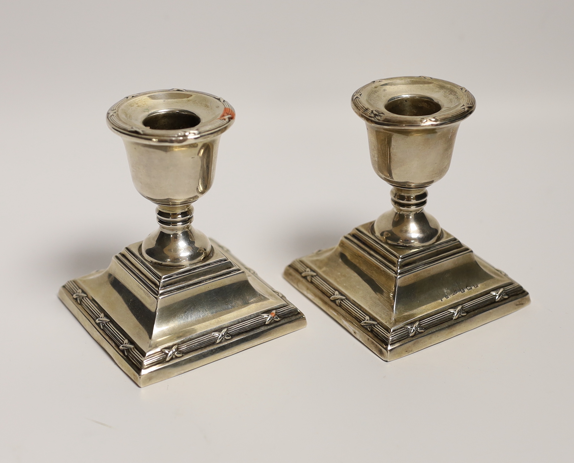 A pair of George V silver mounted dwarf candlesticks, S. Blanckensee & Sons Ltd, Birmingham, 1923, 85mm, weighted.